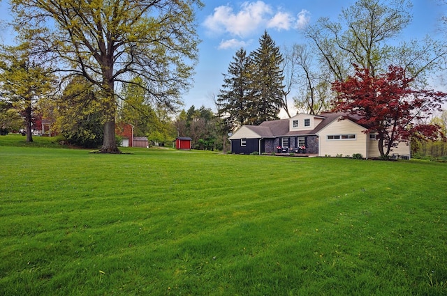 view of yard featuring an outbuilding and a storage shed