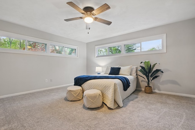 bedroom with baseboards, a ceiling fan, and carpet