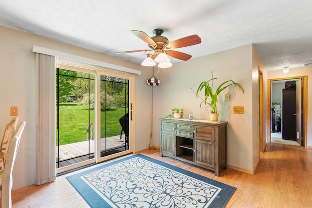 424 Day Rd, Mansfield, OH 44903 - living area with light wood finished floors, a ceiling fan, a textured ceiling, and baseboards
