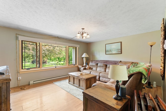424 Day Rd, Mansfield, OH 44903 - living room with a baseboard heating unit, light wood finished floors, a textured ceiling, and a chandelier
