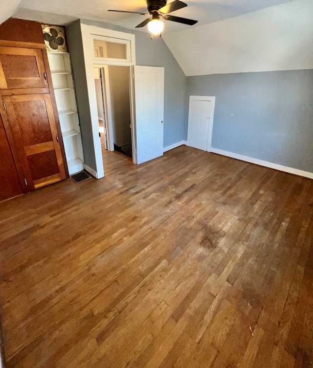 bonus room with vaulted ceiling, wood finished floors, baseboards, and ceiling fan