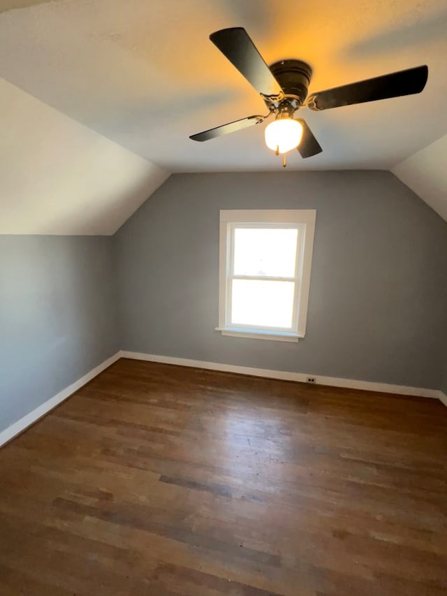 additional living space with lofted ceiling, wood finished floors, and baseboards