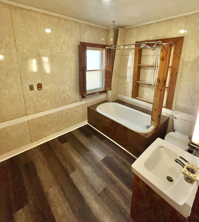 bathroom with toilet, ornamental molding, a combined bath / shower with rainfall shower, wood finished floors, and a sink