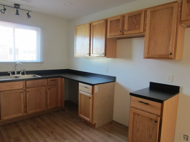 16 Earl Ave, Shelby, OH 44875 - kitchen with a sink, light wood finished floors, dark countertops, and brown cabinetry