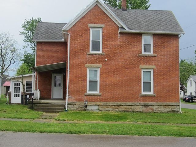 16 Earl Ave, Shelby, OH 44875 - view of front of house with brick siding and a front lawn
