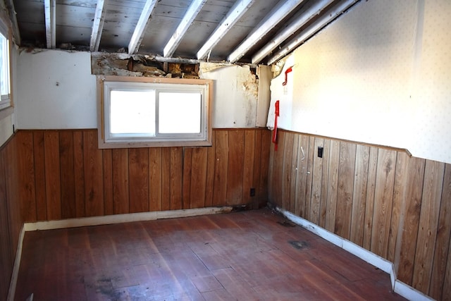 spare room with dark hardwood / wood-style floors and wood walls