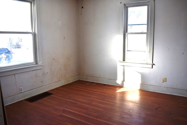 empty room with dark hardwood / wood-style flooring