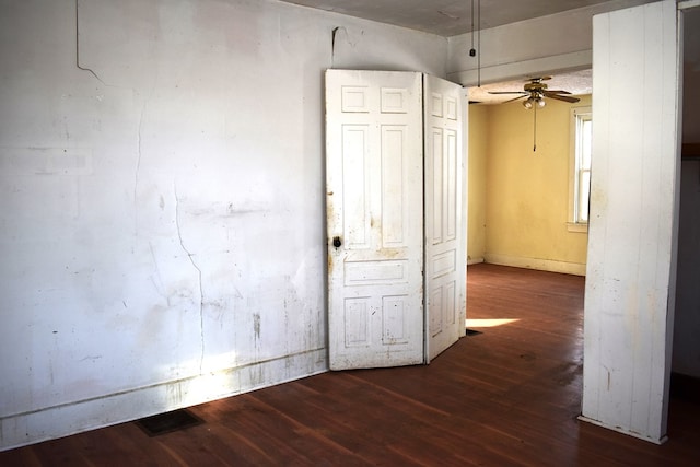 interior space featuring ceiling fan and dark wood-type flooring