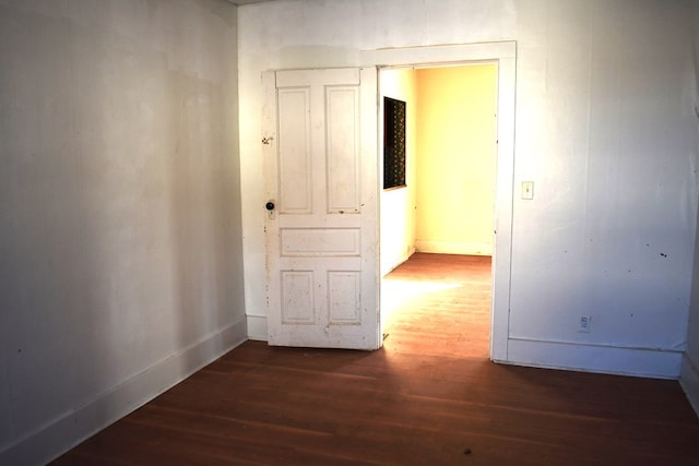 corridor featuring dark wood-type flooring