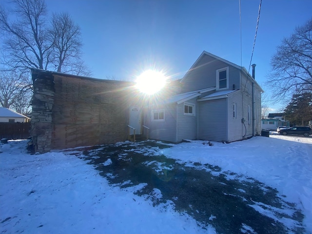 view of snow covered rear of property