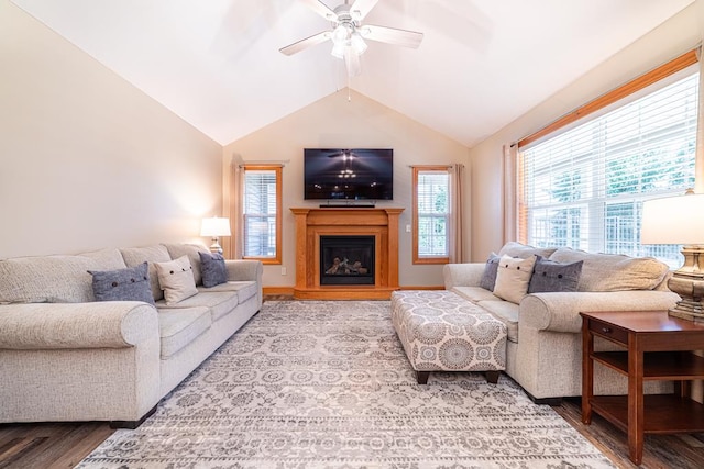 living room featuring a fireplace, lofted ceiling, wood finished floors, and ceiling fan