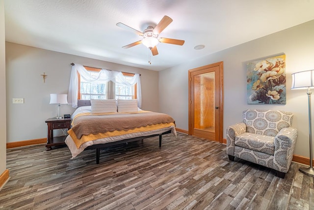 bedroom featuring ceiling fan, baseboards, and wood finished floors