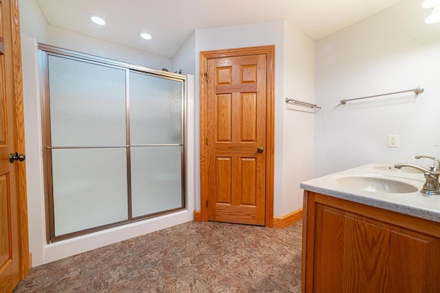 full bathroom featuring a sink, recessed lighting, and a shower stall