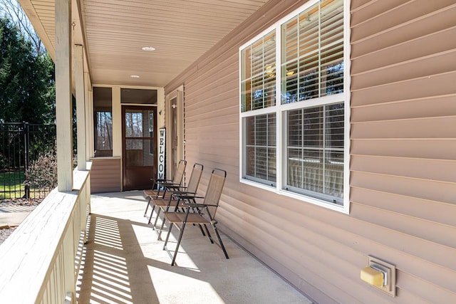 view of patio featuring fence and covered porch