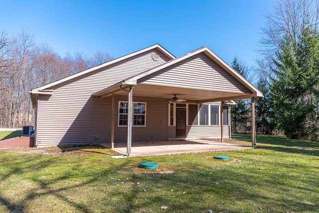 back of property featuring a lawn, central AC, a ceiling fan, and a patio area