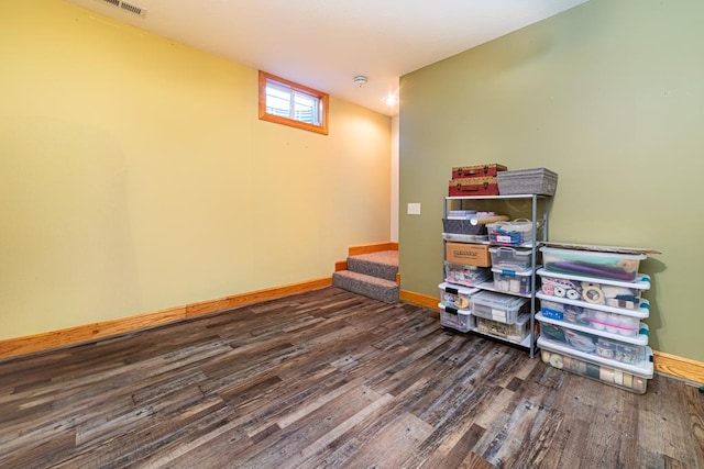 interior space with wood finished floors and baseboards