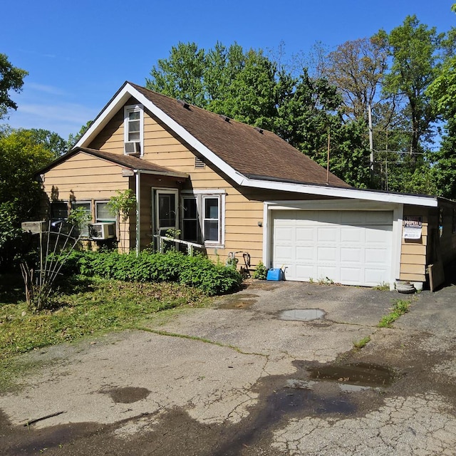 741 Burger Ave, Mansfield, OH 44906 - view of front of property featuring a garage, a shingled roof, and asphalt driveway