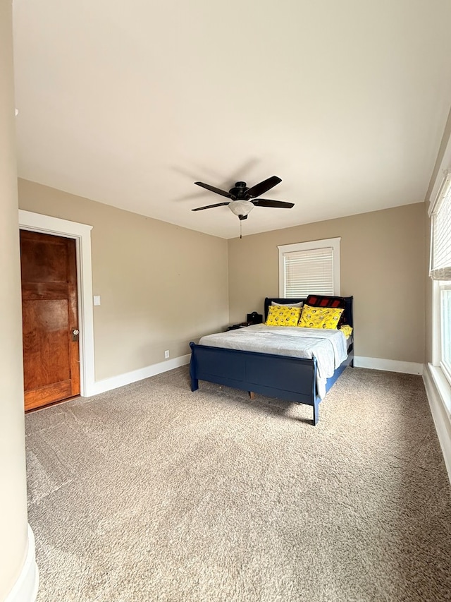 carpeted bedroom with baseboards and ceiling fan
