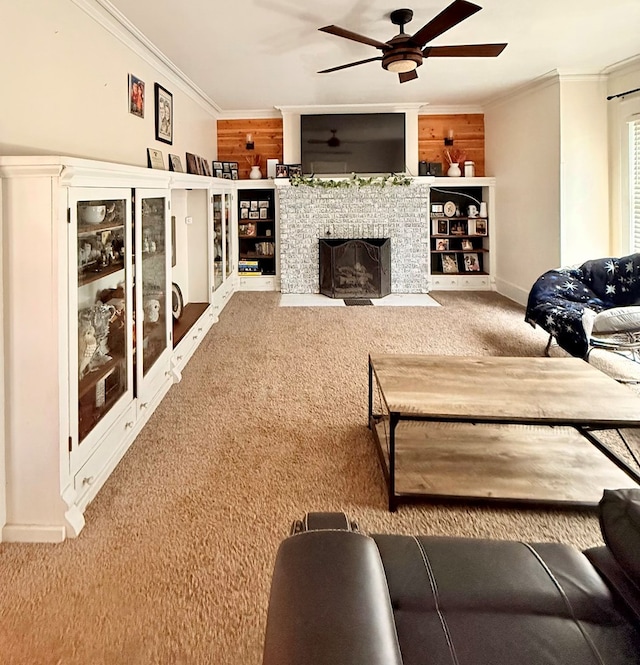 living area featuring carpet, ornamental molding, ceiling fan, a fireplace with flush hearth, and baseboards
