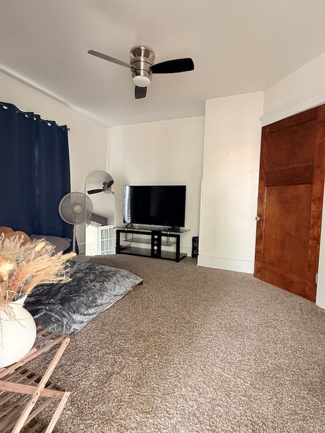 living area with carpet flooring and ceiling fan