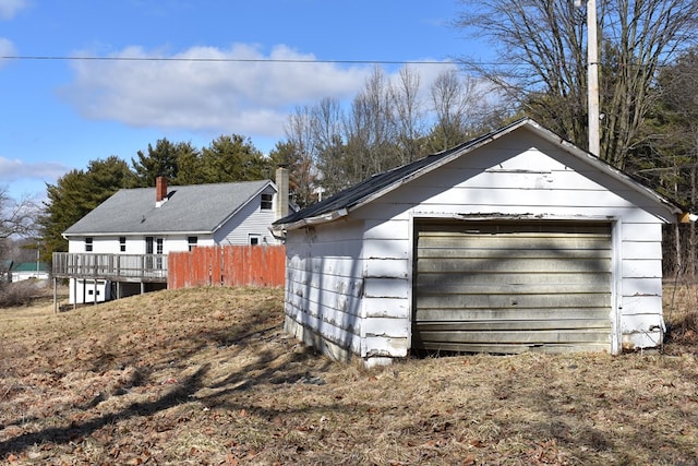 detached garage featuring fence