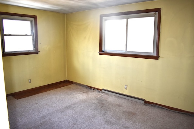 carpeted spare room featuring baseboards and baseboard heating