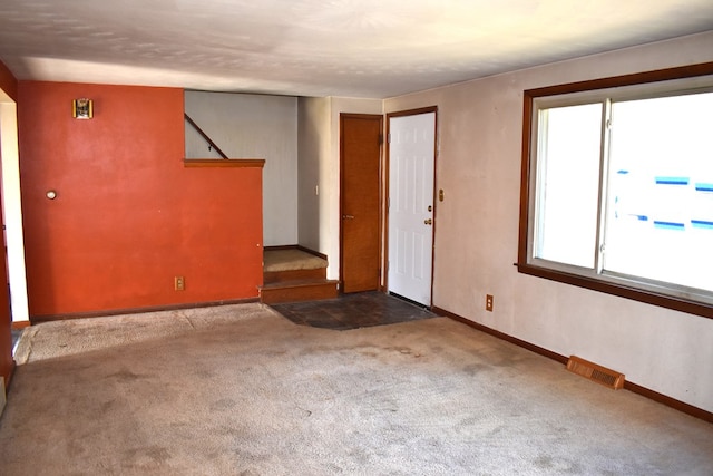 interior space with stairs, visible vents, and baseboards