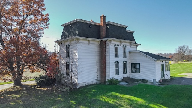 back of house with a lawn