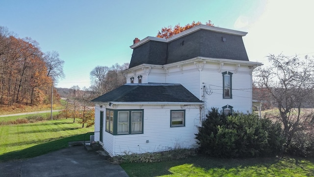 view of property exterior featuring a lawn