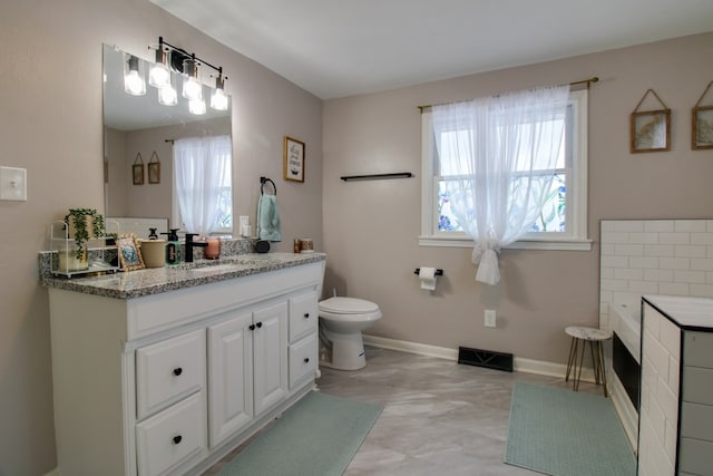 full bathroom with toilet, vanity, visible vents, and baseboards