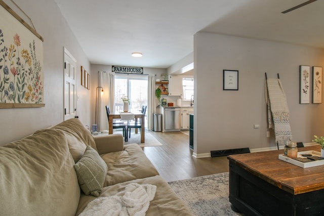 living area featuring baseboards and wood finished floors