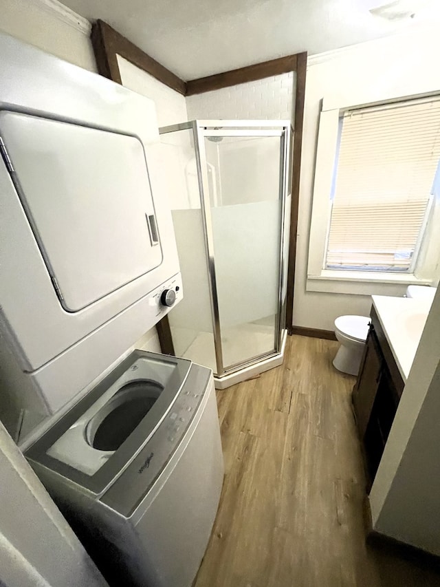 80 Main St, Shelby, OH 44875 - bathroom with stacked washer / dryer, vanity, a stall shower, and wood finished floors