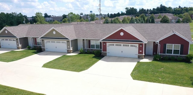 ranch-style home with stone siding, a garage, concrete driveway, and a front lawn