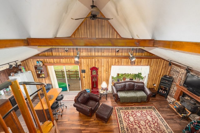 1163 Bowen Rd, Mansfield, OH 44903 - living room with wood walls, a ceiling fan, wood finished floors, and a wood stove
