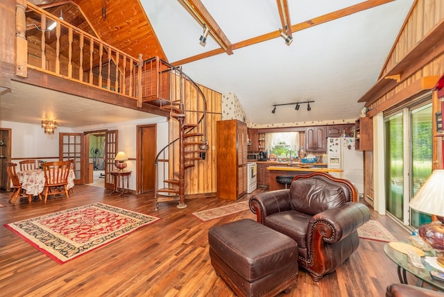 1163 Bowen Rd, Mansfield, OH 44903 - living room featuring rail lighting, stairs, wood finished floors, and high vaulted ceiling