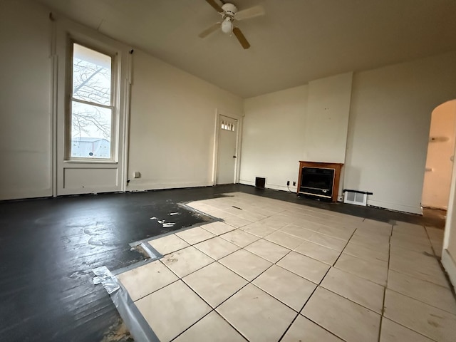 unfurnished living room with ceiling fan