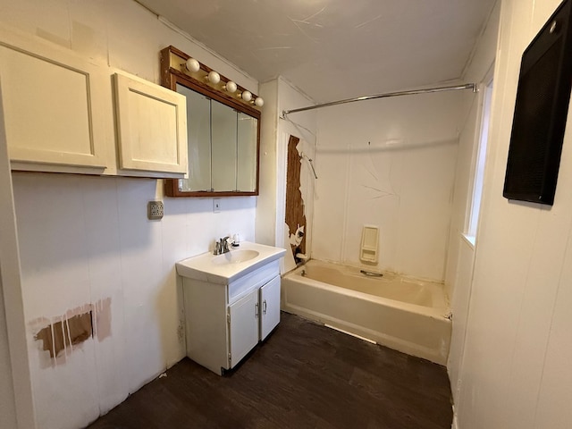 bathroom featuring washtub / shower combination, vanity, and hardwood / wood-style floors