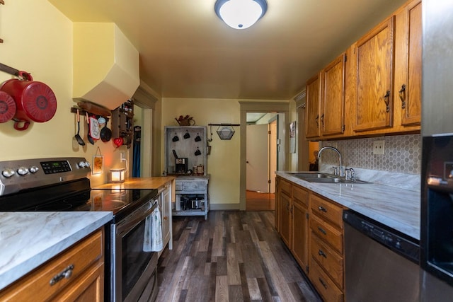780 Pulver List Rd, Mansfield, OH 44905 - kitchen featuring appliances with stainless steel finishes, brown cabinetry, dark wood finished floors, and backsplash
