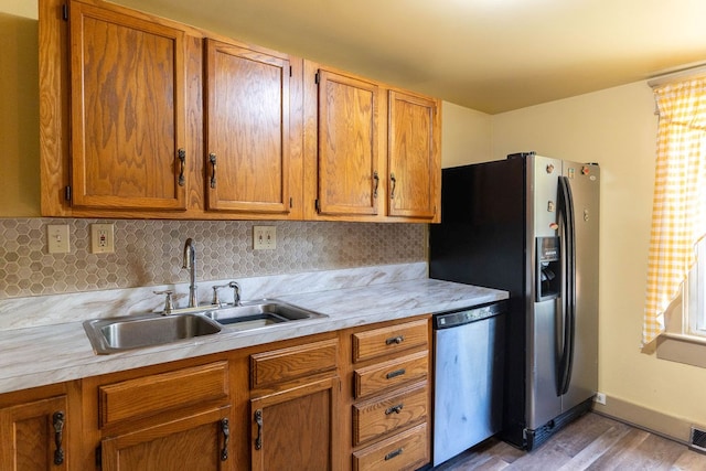 780 Pulver List Rd, Mansfield, OH 44905 - kitchen with stainless steel appliances, light countertops, wood finished floors, and brown cabinetry