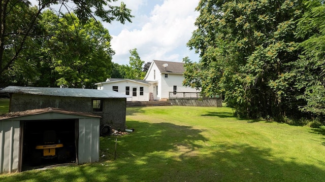 780 Pulver List Rd, Mansfield, OH 44905 - view of green lawn with a storage unit and a wooden deck