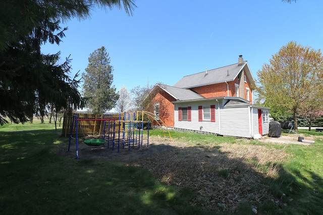 11914 State Route 269, Bellevue, OH 44811 - view of property exterior with a lawn, a chimney, and a playground