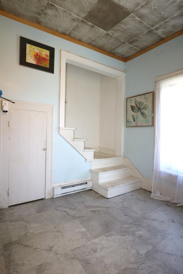 11914 State Route 269, Bellevue, OH 44811 - stairway with crown molding, baseboard heating, concrete flooring, and an ornate ceiling