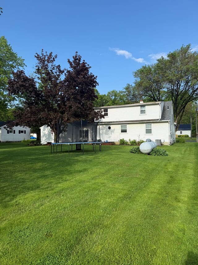623 Bendle Ave, Shelby, OH 44875 - view of green lawn featuring a trampoline