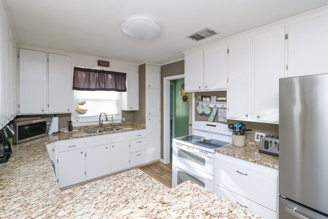 623 Bendle Ave, Shelby, OH 44875 - kitchen featuring appliances with stainless steel finishes, a sink, and white cabinets