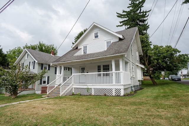 bungalow with covered porch and a front lawn