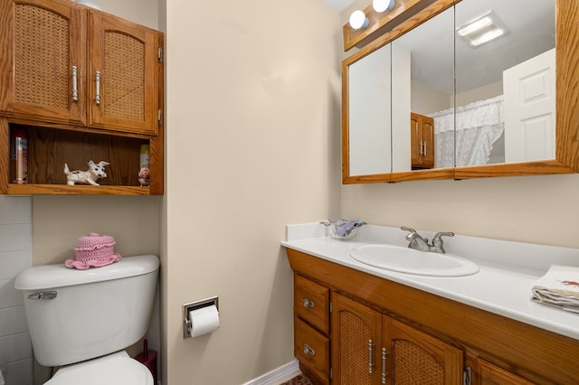 bathroom featuring toilet and vanity