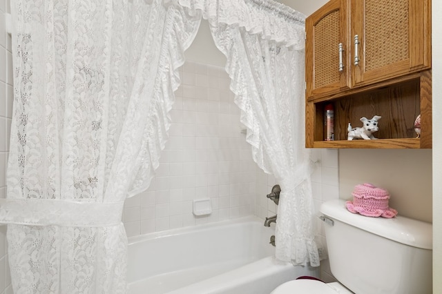 bathroom with toilet and shower / bath combo