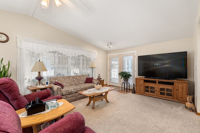 living room with lofted ceiling, carpet, and ceiling fan