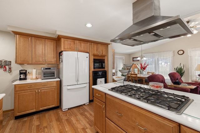 kitchen featuring black appliances, wall chimney range hood, light countertops, and brown cabinets