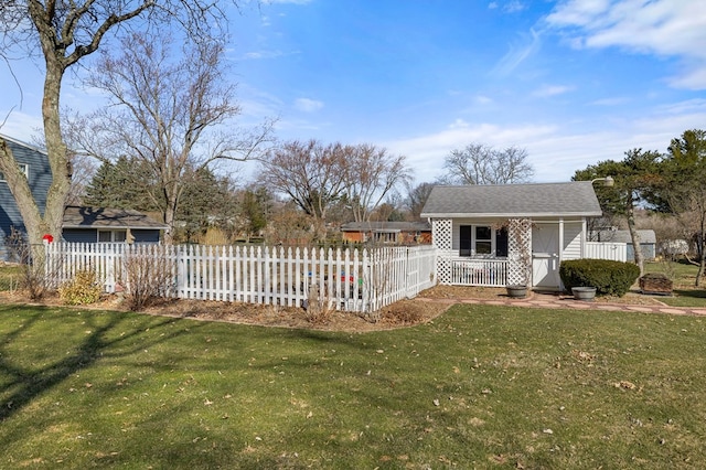 view of yard featuring a fenced front yard and an outbuilding